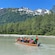 A small tour group paddling away from Glacial Point in a canoe